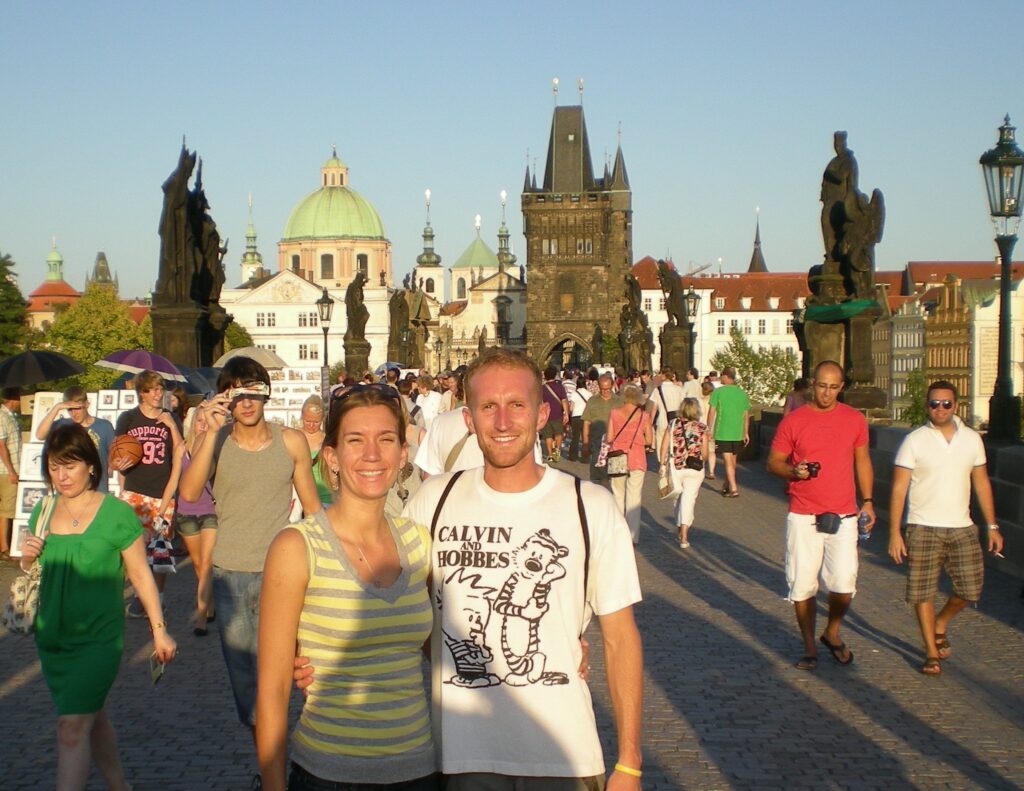 A couple standing on the Charles Bridge in Prague
