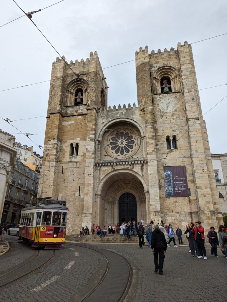 A trolley car going past the Lisbon Cathedral in Portugal