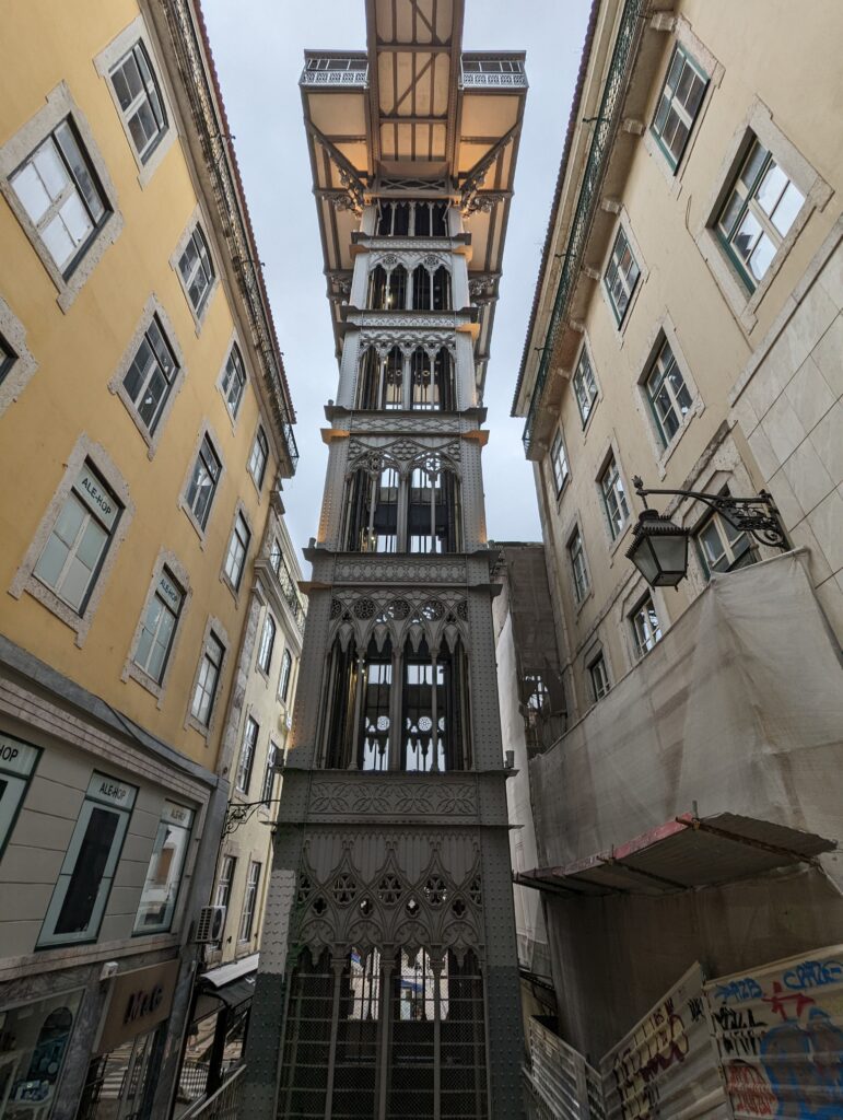 A tall, slim, metal multi-story elevator called the Santa Justa Lift in Lisbon Portugal