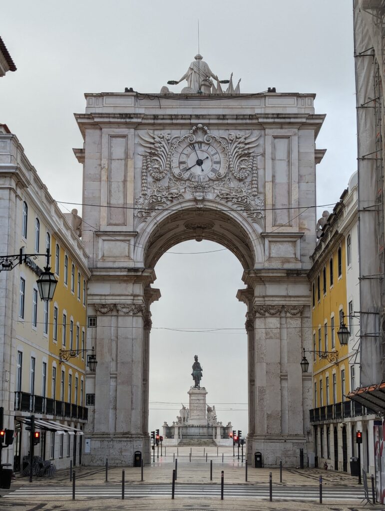 The Arco da Rua Augusta framing a statue in Lisbon, Portugal