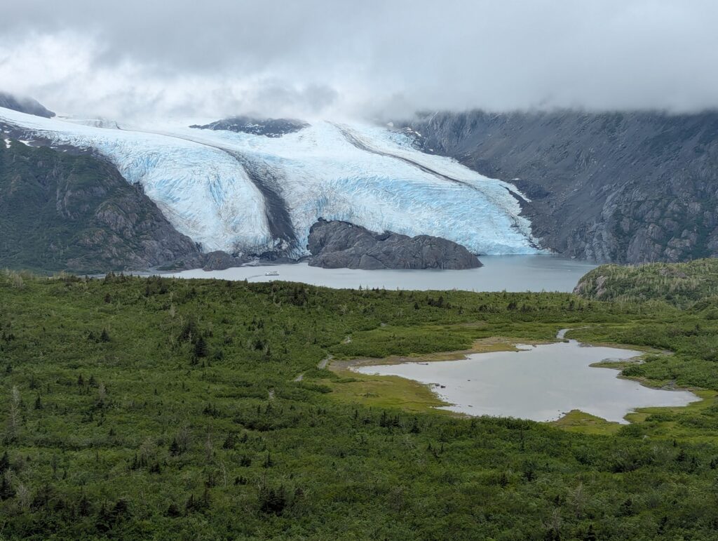 Portage Glacier with a small body of water in the foreground on a cloudy day