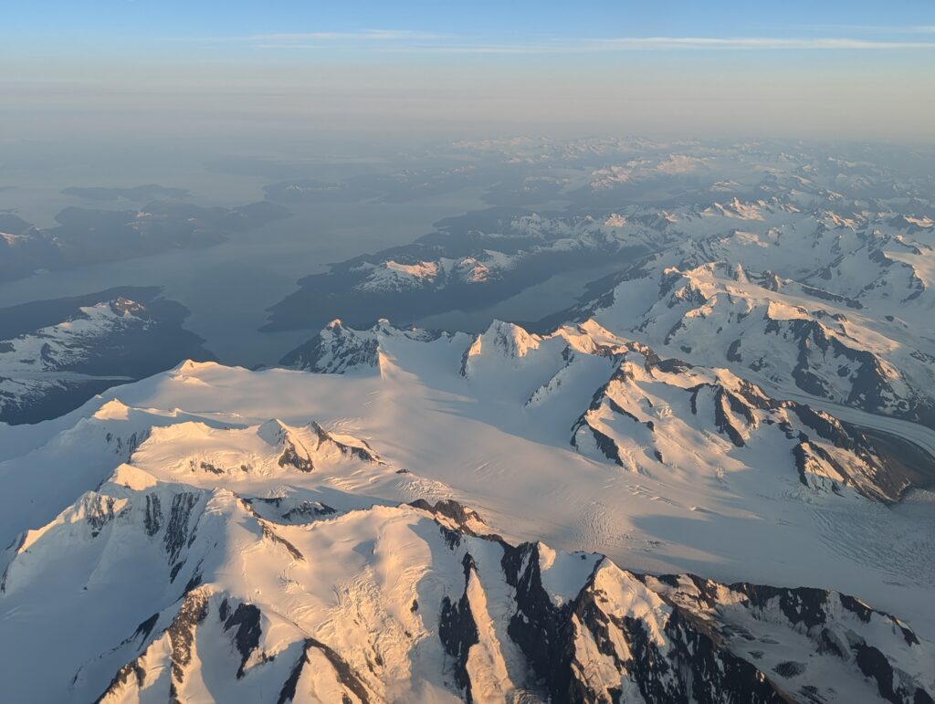 Jagged snow-covered mountains viewed from an airplane near Anchorage